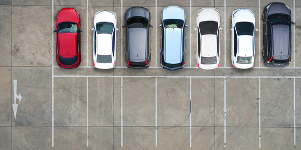 Aerial view of a car park with seven cars