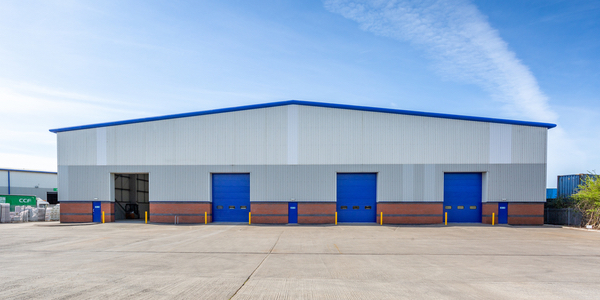 Outside image of a warehouse with four loading doors