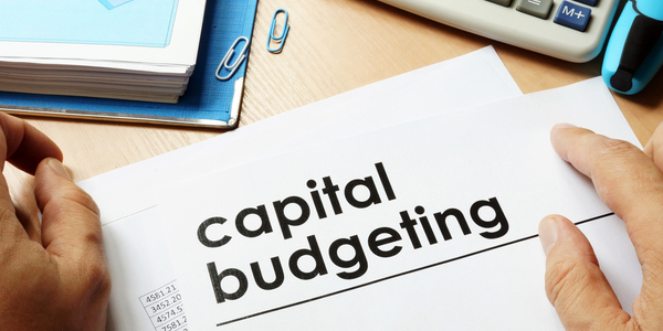 Form on a desk stating capital budgeting